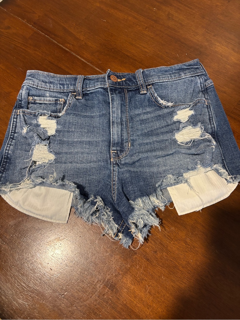 Hollister Distressed High-Rise Denim Shorts - Blue. Frayed hem
